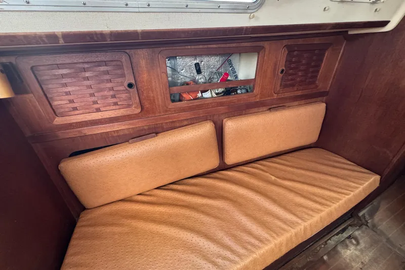 Slide: The Image of Interior of 1983 Sabre 34 sailboat with wooden cabinets and cushioned seating. - 27
