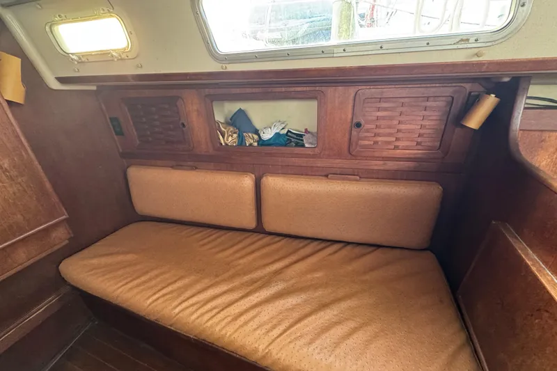 Slide: The Image of Interior of 1983 Sabre 34 sailboat with wooden cabinetry and cushioned seating. - 28