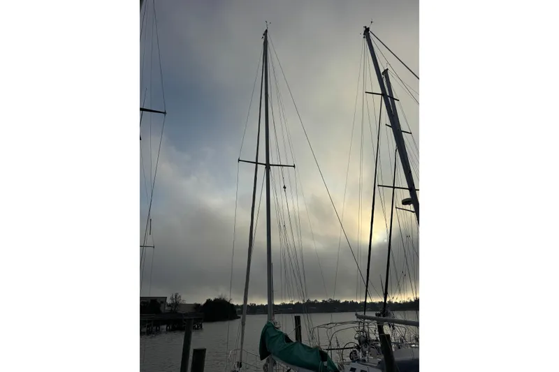 Slide: The Image of Masts of a 1983 Sabre 34 sailboat against a cloudy sky at sunset. - 4