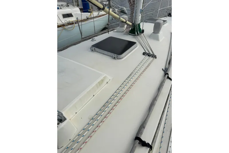 Slide: The Image of 1983 Sabre 34 sailboat deck with rigging and hatch, showcasing nautical design. - 8
