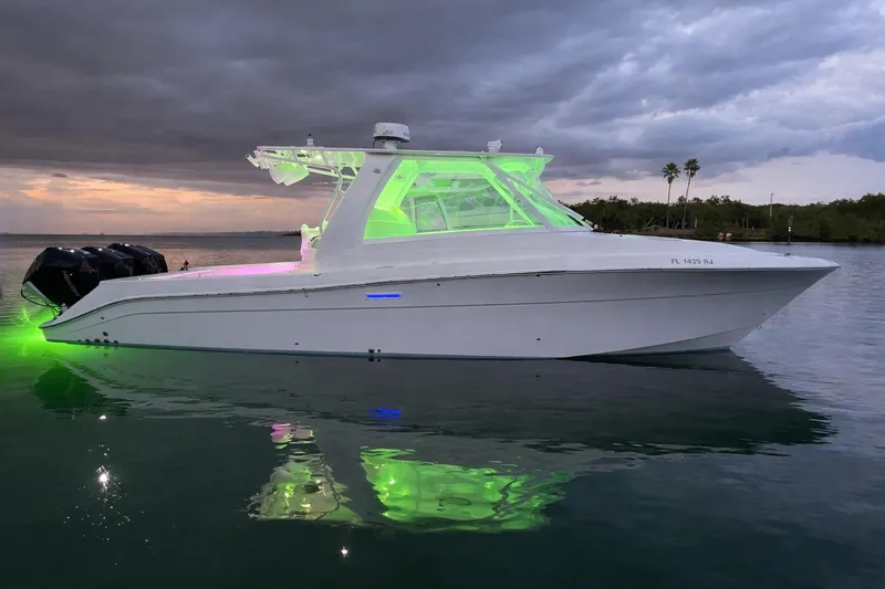 Slide: The Image of 2008 Hydra-Sports Vector 3500 VX boat with glowing green lights on calm water. - 11