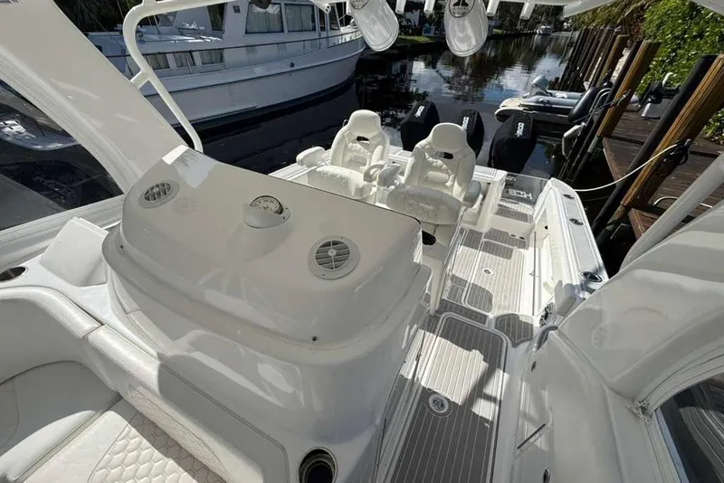Slide: The Image of 2008 Hydra-Sports Vector 3500 VX boat interior with seating and controls, docked near other boats. - 32