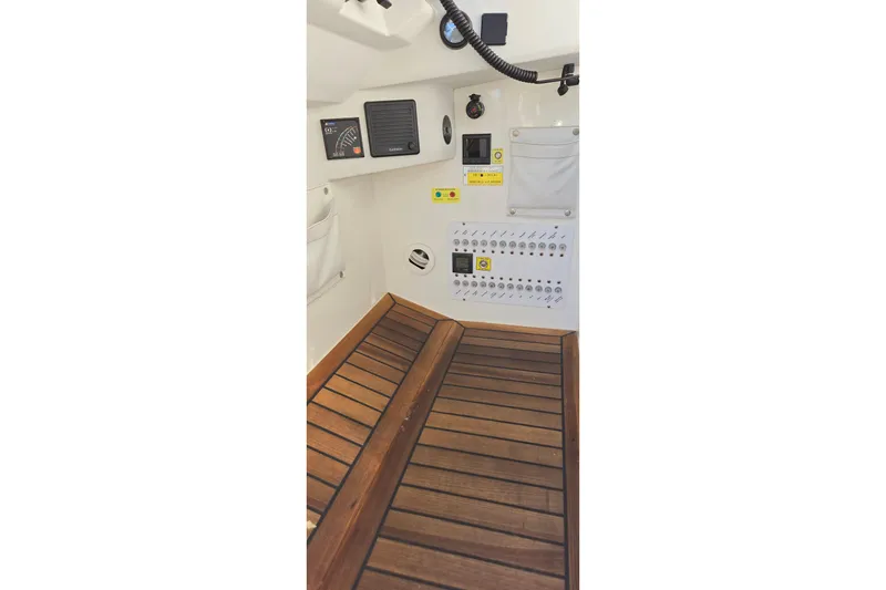 Slide: The Image of 2025 Marex 310 Sun Cruiser interior with wooden flooring and control panel. - 14