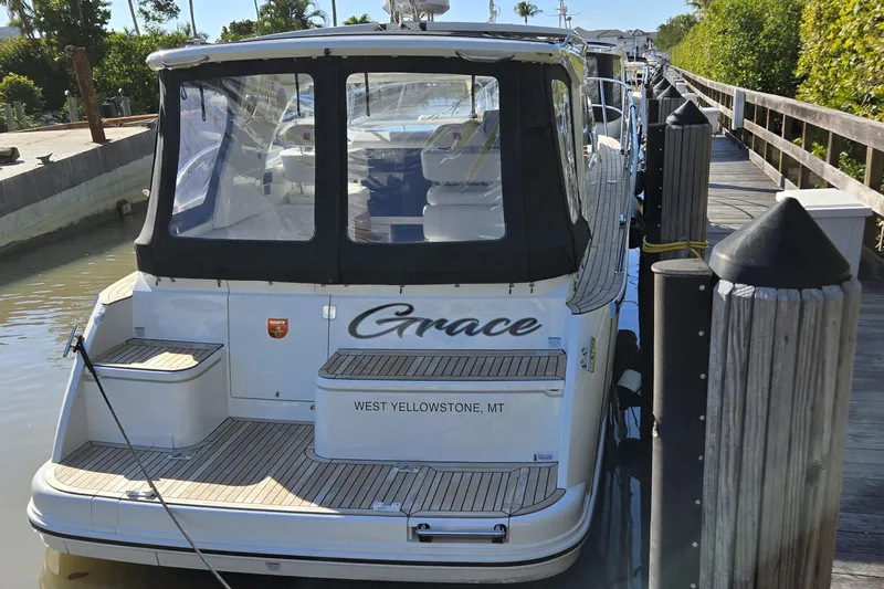 Slide: The Image of 2025 Marex 310 Sun Cruiser docked, rear view with canopy, named "Grace," West Yellowstone, MT. - 20