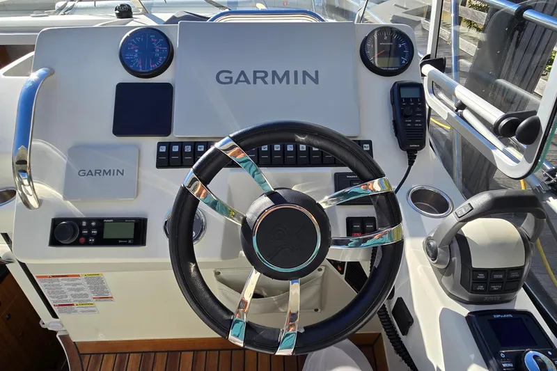 Slide: The Image of Helm of 2025 Marex 310 Sun Cruiser with Garmin navigation system and controls. - 22