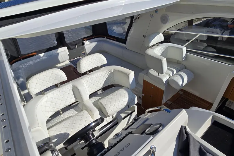 Slide: The Image of Luxurious interior of 2025 Marex 310 Sun Cruiser with white quilted seating. - 25