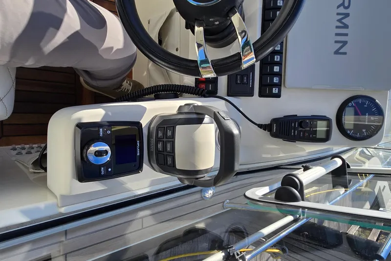 Slide: The Image of Cockpit of 2025 Marex 310 Sun Cruiser with steering wheel and navigation controls. - 28