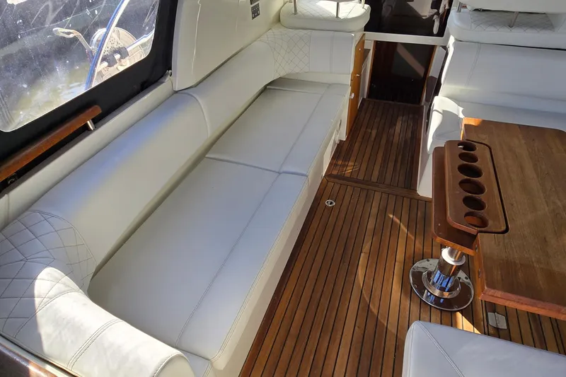 Slide: The Image of Interior of 2025 Marex 310 Sun Cruiser with white seating and wooden flooring. - 30