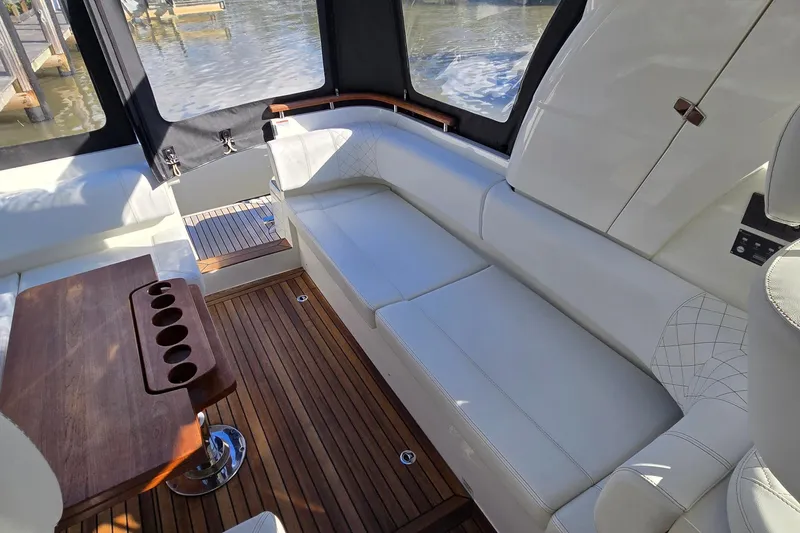 Slide: The Image of Interior of 2025 Marex 310 Sun Cruiser with white seating and wooden table. - 33