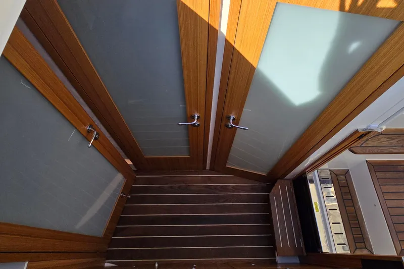 Slide: The Image of Interior view of 2025 Marex 310 Sun Cruiser with wooden doors and flooring. - 37