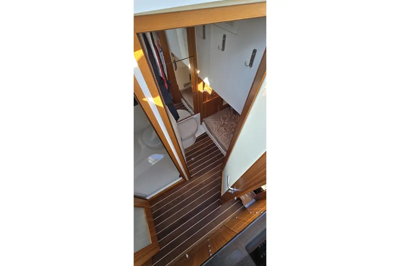 Slide: The Image of Interior view of 2025 Marex 310 Sun Cruiser with wooden flooring and cozy cabin space. - 39