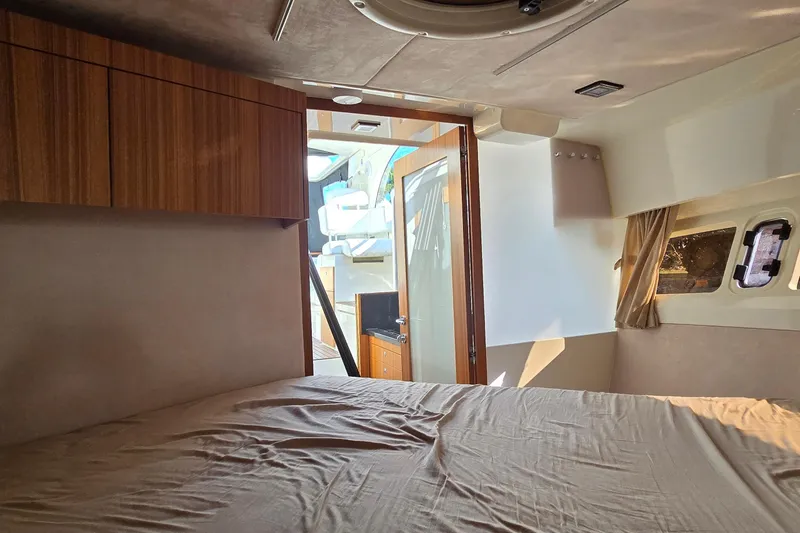 Slide: The Image of Interior cabin of 2025 Marex 310 Sun Cruiser with bed and wooden cabinets. - 45