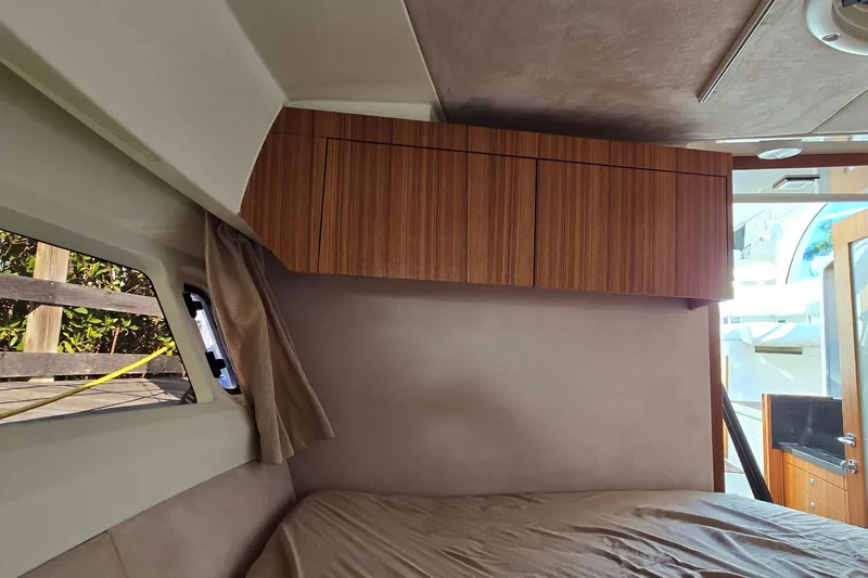 Slide: The Image of Interior cabin of 2025 Marex 310 Sun Cruiser with wooden cabinets and window view. - 46