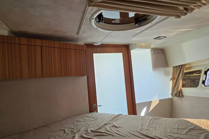 Slide: The Image of Interior cabin of 2025 Marex 310 Sun Cruiser with wooden accents and natural light. - 47