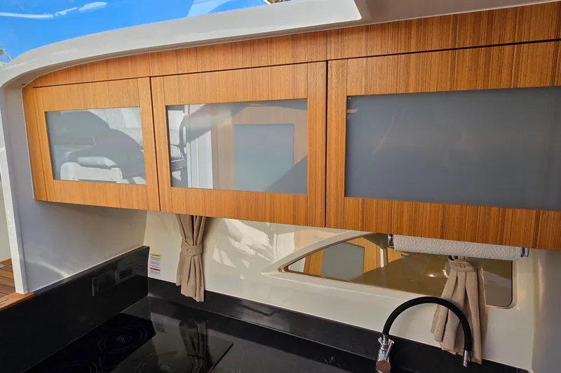 Slide: The Image of Modern kitchen interior of 2025 Marex 310 Sun Cruiser with wooden cabinets and sleek design. - 50