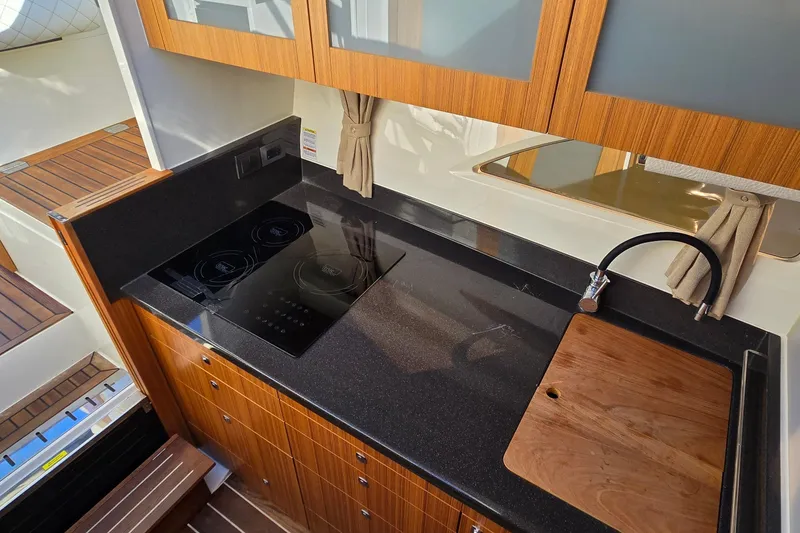Slide: The Image of Modern kitchen in 2025 Marex 310 Sun Cruiser with sleek countertops and induction cooktop. - 51