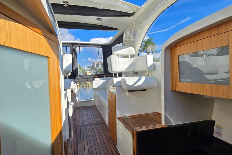 Slide: The Image of 2025 Marex 310 Sun Cruiser interior with modern seating and wooden accents. - 52