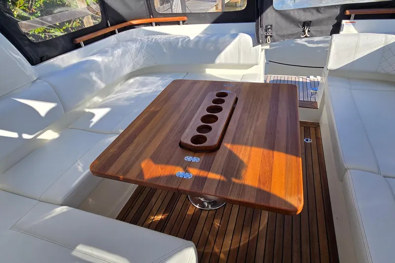 Slide: The Image of Luxurious interior of 2025 Marex 310 Sun Cruiser with elegant wooden table and white seating. - 53