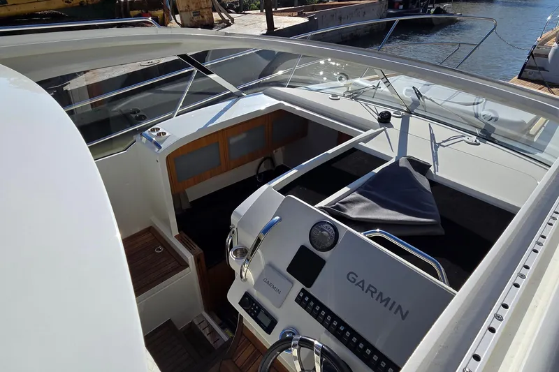 Slide: The Image of 2025 Marex 310 Sun Cruiser cockpit with Garmin navigation system, sleek design, and spacious layout. - 58