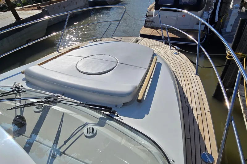 Slide: The Image of 2025 Marex 310 Sun Cruiser boat with sleek deck design and sunbathing area. - 59