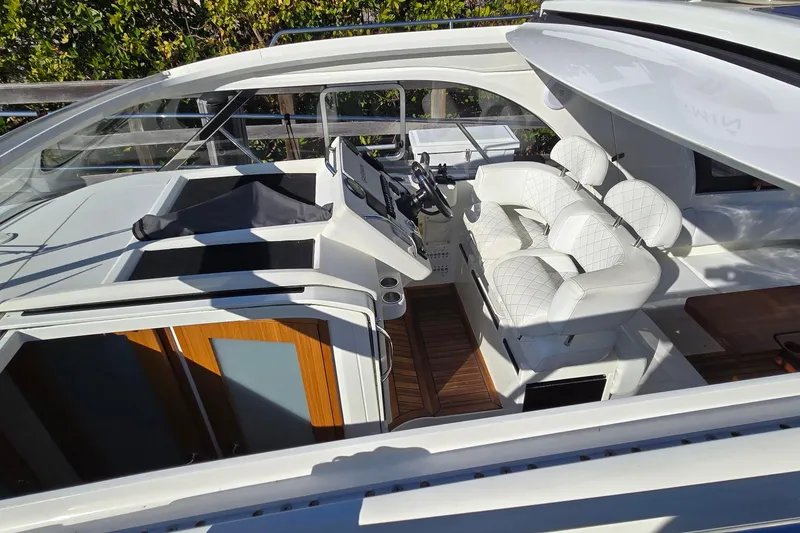 Slide: The Image of 2025 Marex 310 Sun Cruiser cockpit with white seating and modern controls. - 60