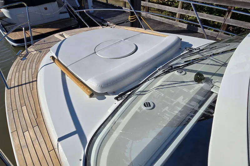 Slide: The Image of 2025 Marex 310 Sun Cruiser boat deck with sleek design and wooden accents. - 63