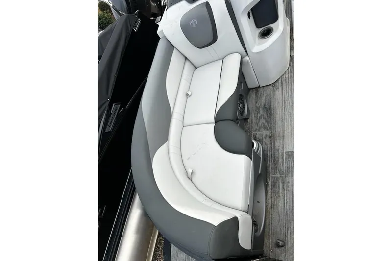 Slide: The Image of 2022 Tahoe Pontoon LTZ Quad Lounger with gray and white seating on a wooden deck. - 10