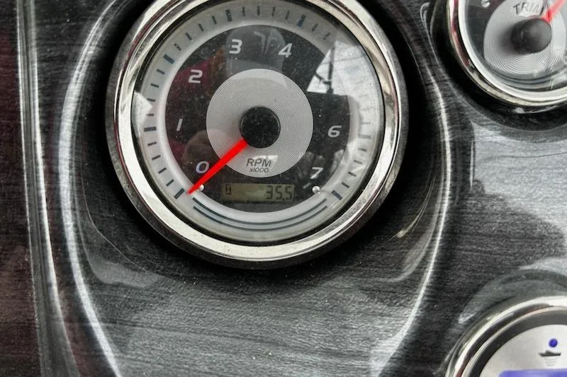 Slide: The Image of Close-up of 2022 Tahoe Pontoon LTZ Quad Lounger RPM gauge displaying 355 hours. - 11