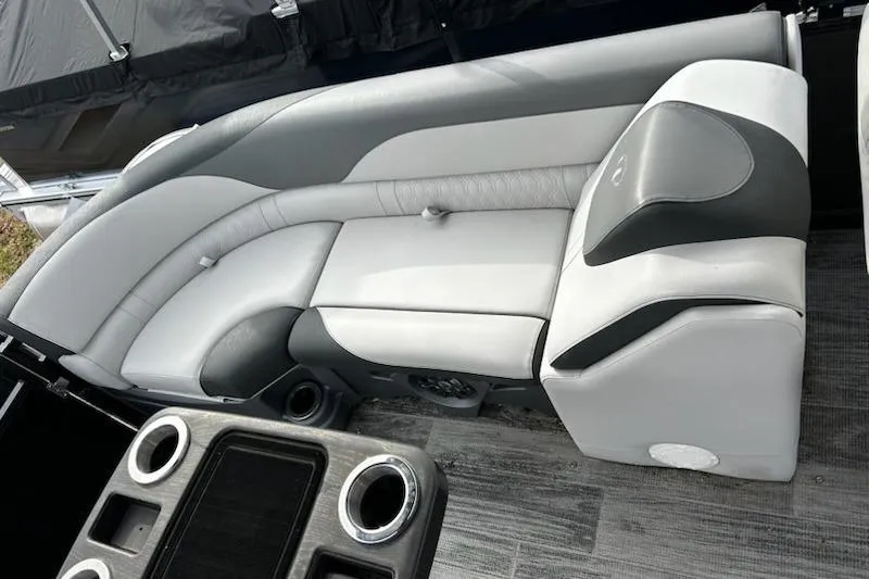 Slide: The Image of 2022 Tahoe Pontoon LTZ Quad Lounger interior with gray seating and cup holders. - 14