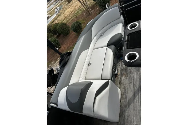 Slide: The Image of 2022 Tahoe Pontoon LTZ Quad Lounger with gray and white seating, cup holders, and wood-style flooring. - 15