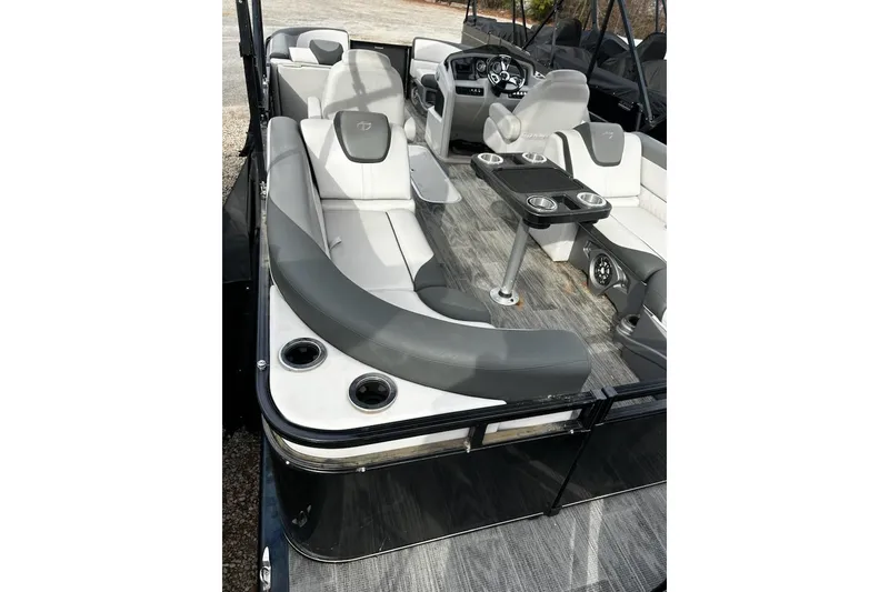 Slide: The Image of 2022 Tahoe Pontoon LTZ Quad Lounger interior with gray seating and cup holders. - 16