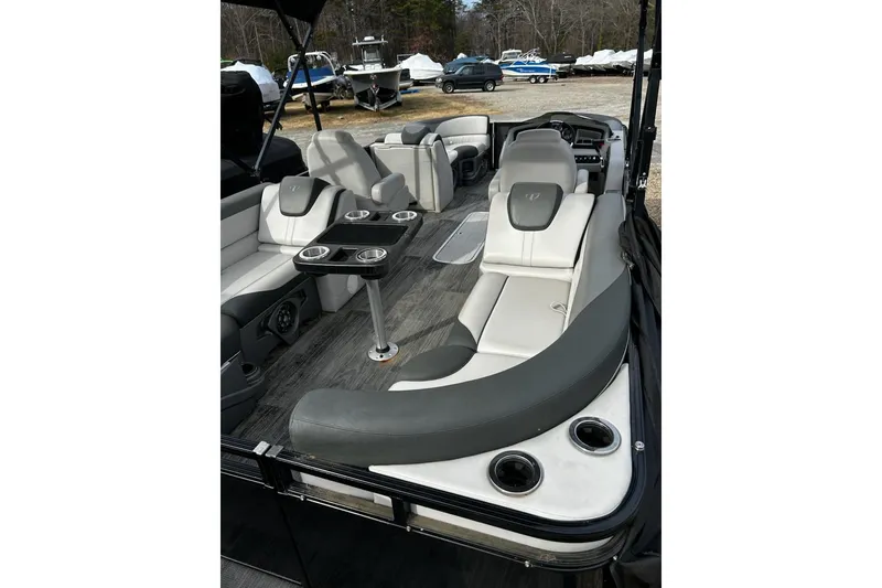 Slide: The Image of 2022 Tahoe Pontoon LTZ Quad Lounger with luxurious seating and cup holders. - 17