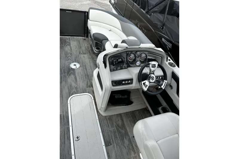 Slide: The Image of 2022 Tahoe Pontoon LTZ Quad Lounger interior with sleek dashboard and comfortable seating. - 5