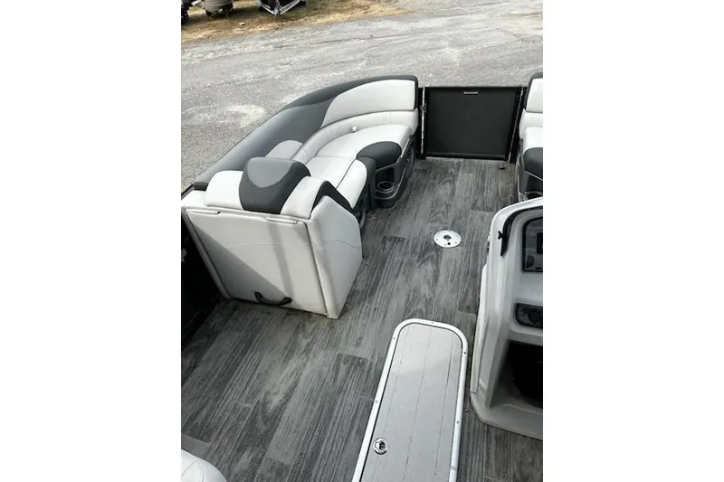 Slide: The Image of 2022 Tahoe Pontoon LTZ Quad Lounger interior with gray seating and wood-style flooring. - 6