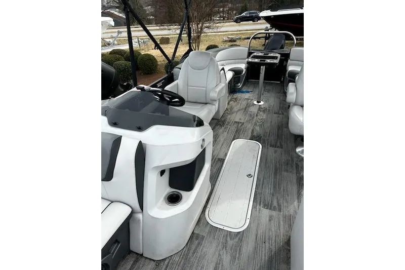 Slide: The Image of 2022 Tahoe Pontoon LTZ Quad Lounger interior with sleek seating and modern dashboard. - 7