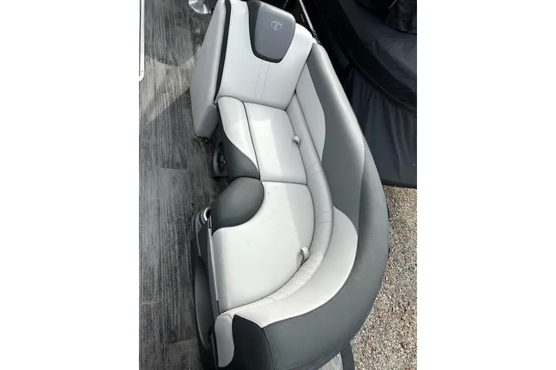 Slide: The Image of 2022 Tahoe Pontoon LTZ Quad Lounger with gray and white seating on a wooden deck. - 9