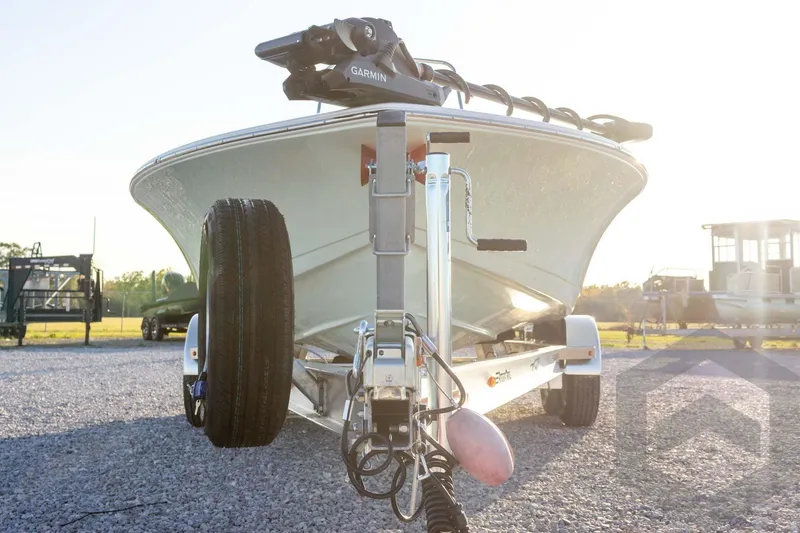 Slide: The Image of 2026 Tidewater 2110 Bay Max boat on trailer, featuring Garmin equipment, in sunny outdoor setting. - 20