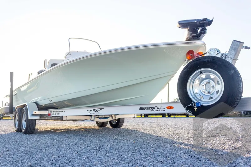 Slide: The Image of 2026 Tidewater 2110 Bay Max boat on AmeraTrail trailer, parked on gravel. - 21