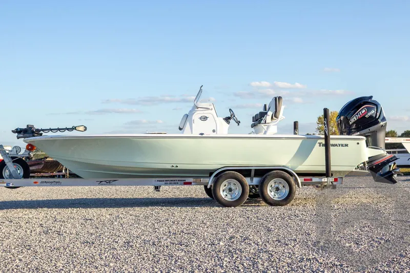 Slide: The Image of 2026 Tidewater 2110 Bay Max boat on trailer, parked on gravel, under clear sky. - 26