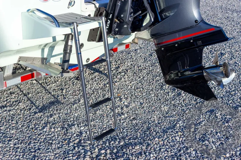 Slide: The Image of 2026 Tidewater 2110 Bay Max boat with ladder and outboard motor on gravel. - 37