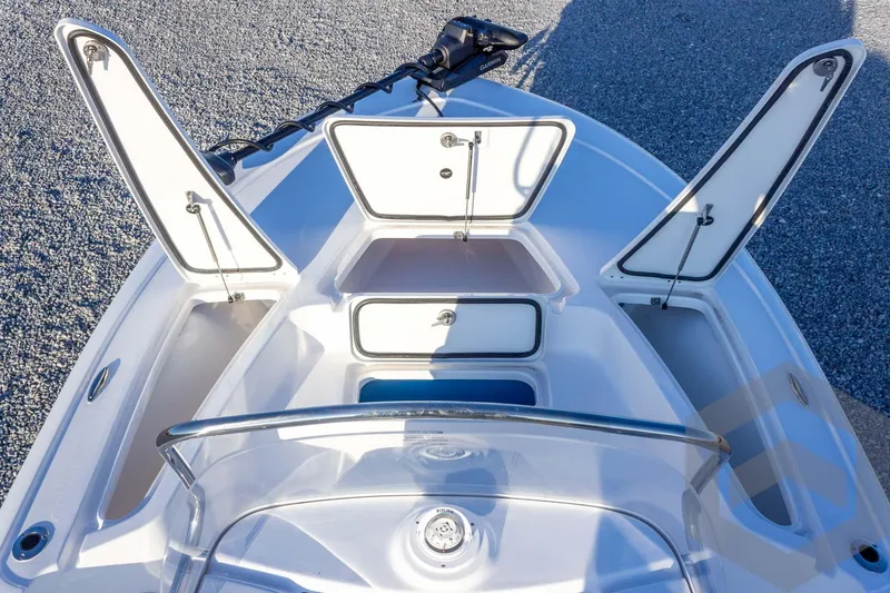 Slide: The Image of 2026 Tidewater 2110 Bay Max boat with open storage compartments and sleek design. - 39