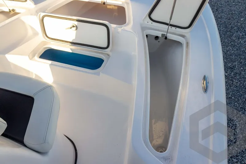 Slide: The Image of 2026 Tidewater 2110 Bay Max boat interior with open storage compartments. - 41