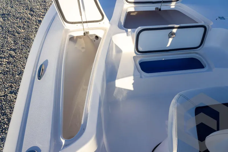 Slide: The Image of 2026 Tidewater 2110 Bay Max boat interior with open storage compartments. - 42