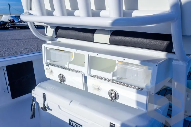 Slide: The Image of 2026 Tidewater 2110 Bay Max boat with storage compartments and YETI cooler. - 51