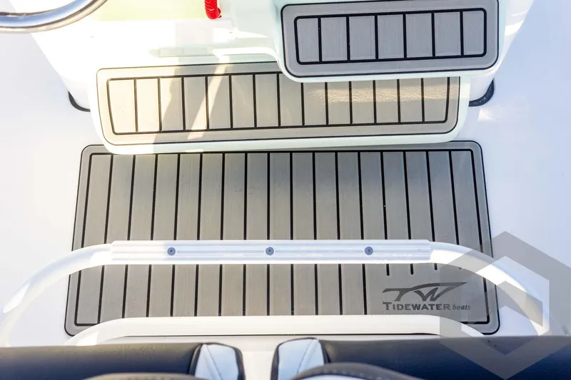 Slide: The Image of 2026 Tidewater 2110 Bay Max boat deck with non-slip flooring and branded logo. - 59
