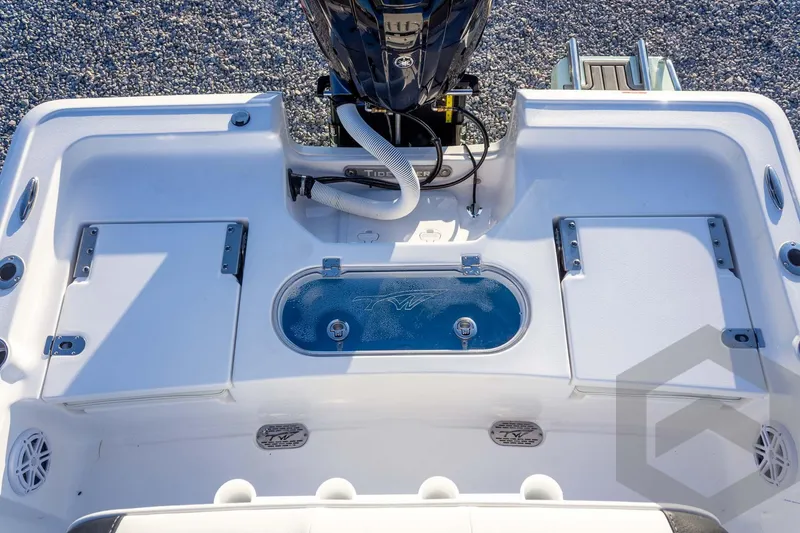 Slide: The Image of 2026 Tidewater 2110 Bay Max boat deck with storage compartments and motor. - 60