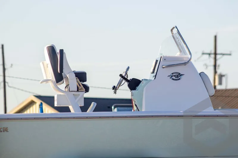 Slide: The Image of 2026 Tidewater 2110 Bay Max boat console and seating, side view. - 9