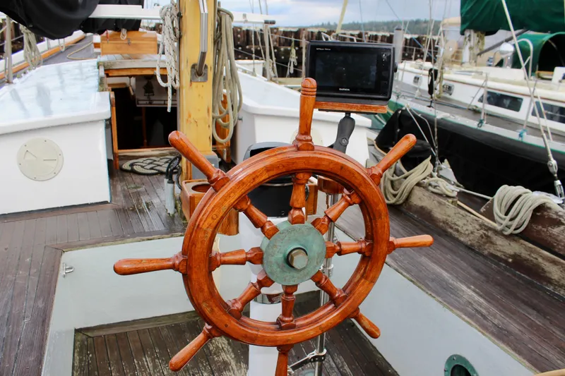 Slide: The Image of Wooden helm of a 1975 William Garden Porpoise sailboat with navigation equipment. - 11