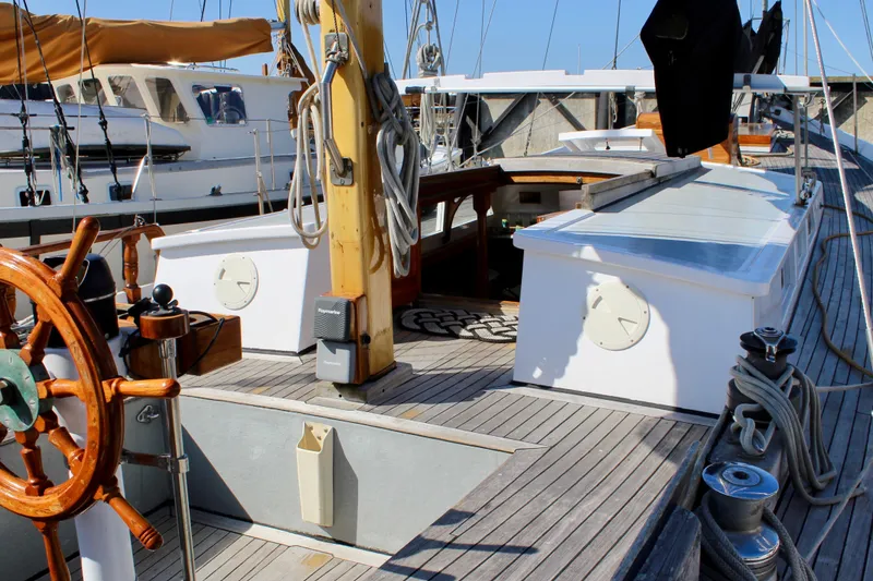 Slide: The Image of 1975 William Garden Porpoise sailboat with wooden deck and steering wheel. - 14