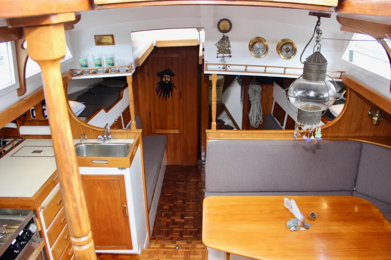 Slide: The Image of Interior of a 1975 William Garden Porpoise sailboat with wooden furnishings and nautical decor. - 15